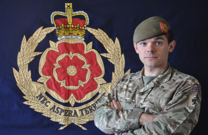 Paul in uniform in front of his Regimental Flag