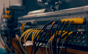 A close up of a computer with wires and cables